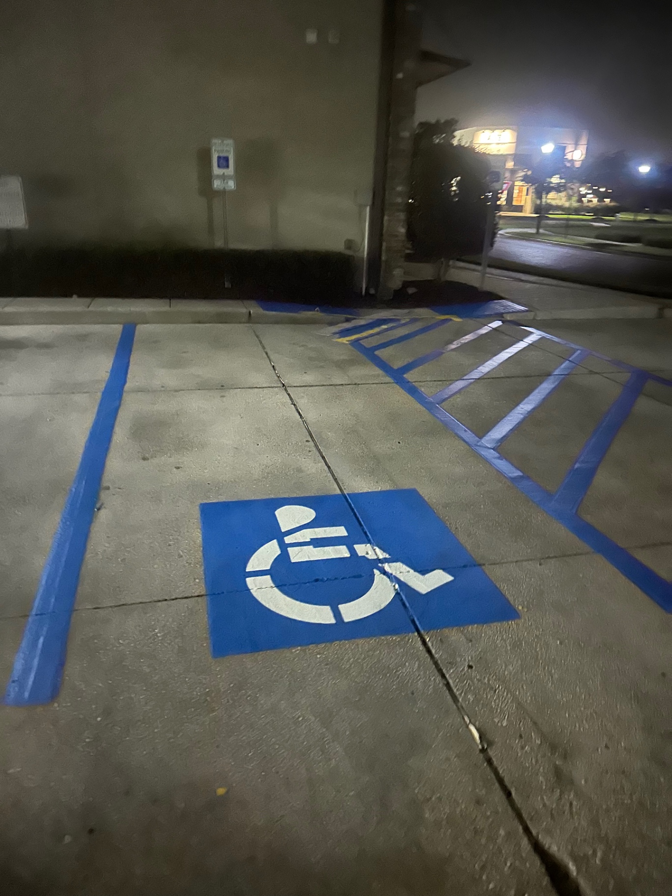 Freshly striped accessible parking space completed at night
