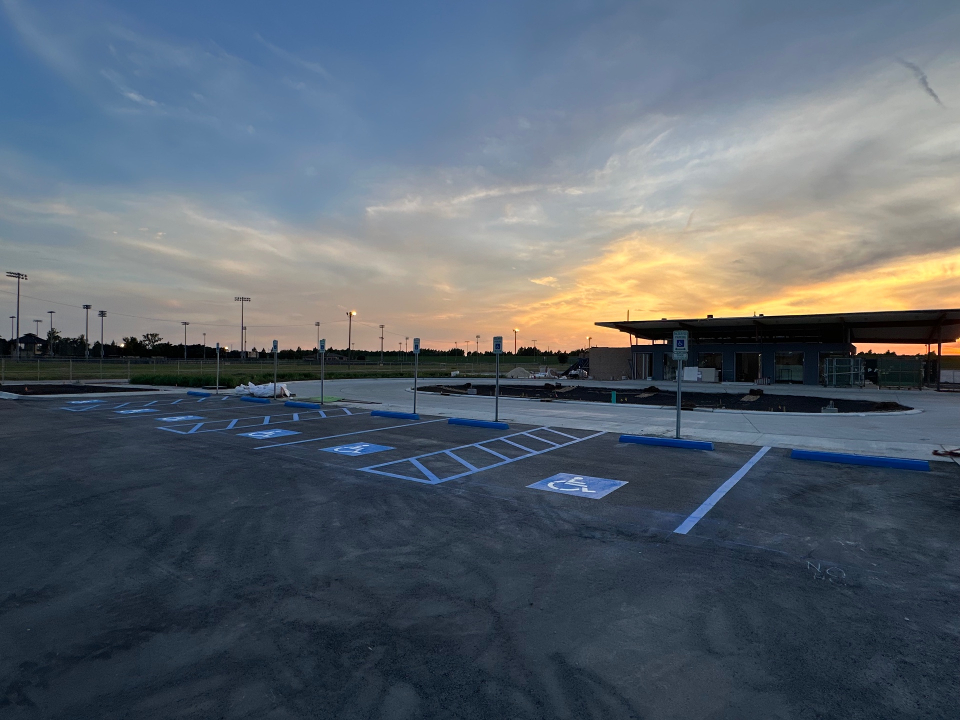 New accessible parking spaces at a commercial property during sunset